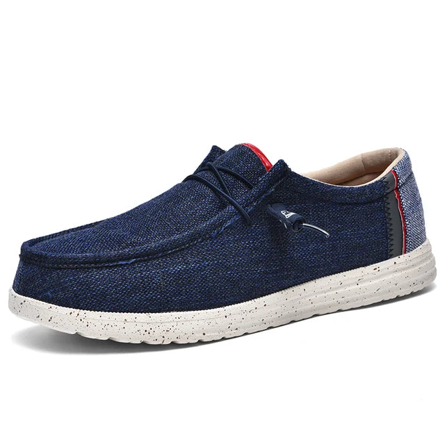 Stijlvolle en comfortabele blauwe canvas herenschoenen met een ademende bovenkant en een lichte, flexibele zool. Deze slip-on schoenen zijn ideaal voor dagelijks gebruik en bieden zowel comfort als een moderne uitstraling. Perfect voor een casual en ontspannen look.
