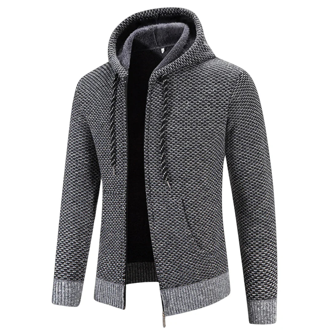 Faloro stijlvolle hoodie in grijs met een warme voering en capuchon. De hoodie heeft een ritssluiting, geribbelde boorden en een subtiel geweven patroon. Perfect voor casual gebruik tijdens koude dagen, biedt comfort en een trendy uitstraling.