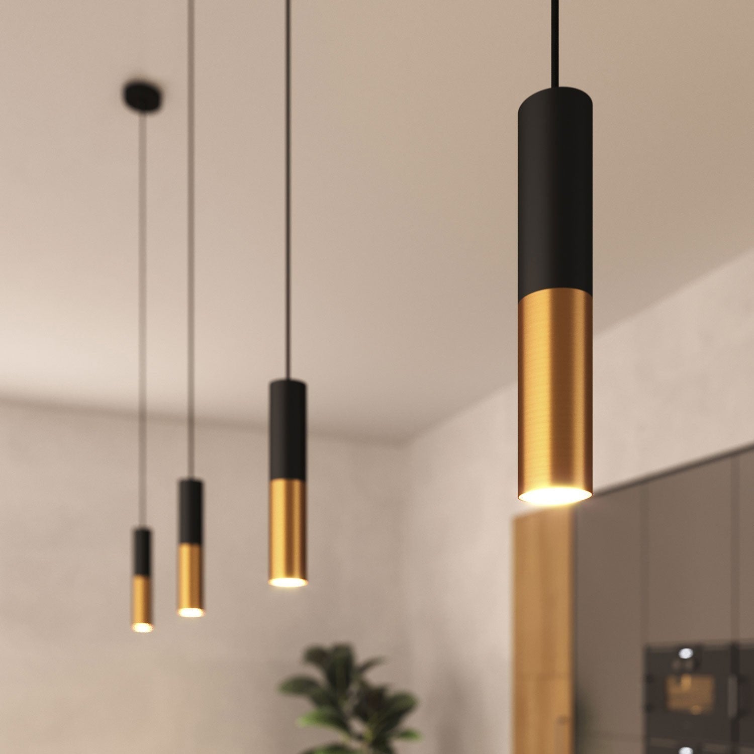 Een stijlvolle set van zwarte en gouden hanglampen die in een modern interieur hangen en een elegante sfeer creëren. De hanglampen hebben een slank ontwerp met zwarte cilindervormige bovenkanten en gouden bases, die een zacht licht naar beneden werpen.