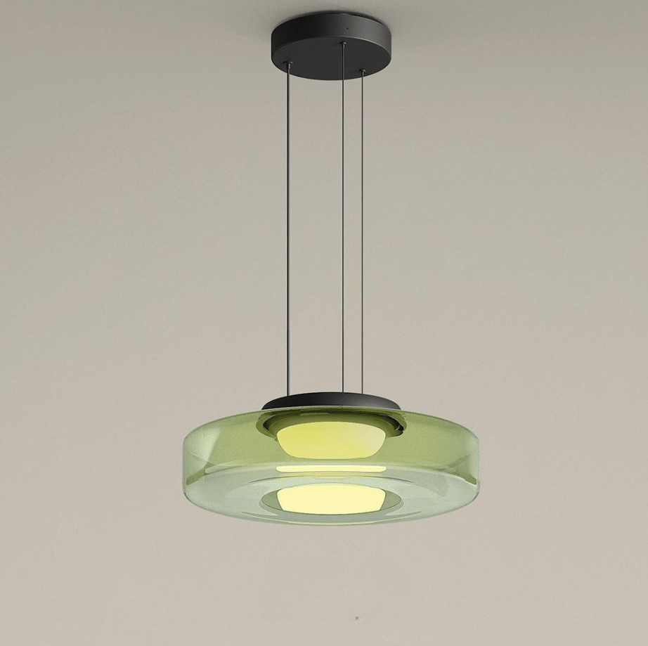 Deze Bauhaus hanglamp met een heldere groene glazen schijf en subtiele lichtuitstraling heeft een minimalistisch ontwerp. Het strakke, moderne uiterlijk is een statement in iedere kamer, terwijl de lichteffecten een rustgevende sfeer creëren. Perfect voor het verfraaien van moderne interieurs, van lounges tot eetkamers.