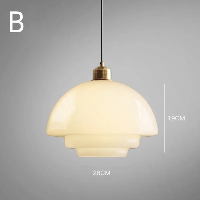 A white glass pendant lamp featuring a soft, curved shape with a brass fixture, suspended from a black cord. The lamp emits a warm, elegant glow, making it a sophisticated addition to any modern home. The dimensions of the lamp are indicated, measuring 28cm in width and 19cm in height.