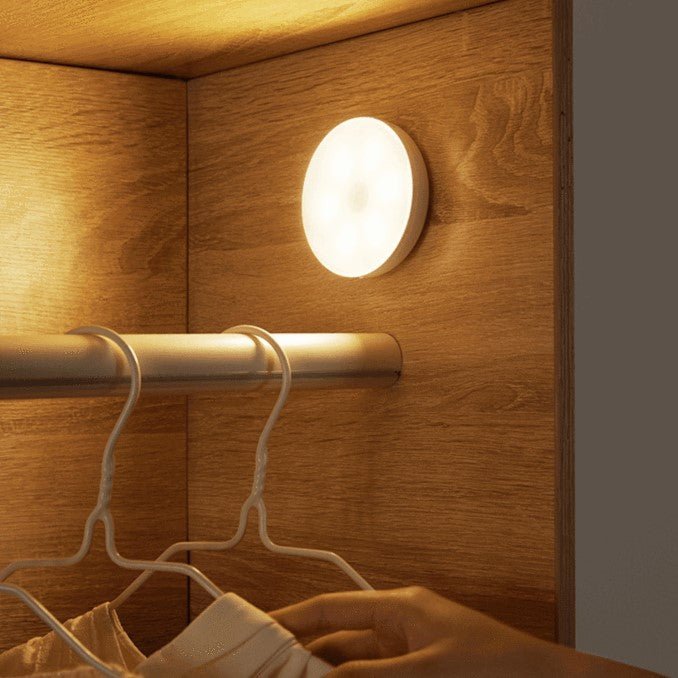 The LumoGlow Motion Lamp, installed in a closet, provides efficient, energy-saving lighting that activates automatically with motion. Its slim, round design offers a soft and bright glow, perfect for illuminating tight spaces and ensuring convenience and safety.