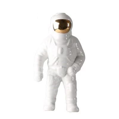 OriaDecor bloemenhouder in de vorm van een astronaut, vervaardigd uit glanzend wit keramiek met een gouden helm. Modern en speels ontwerp, ideaal als decoratief item of plantenhouder voor een eigentijdse uitstraling in huis of kantoor.
