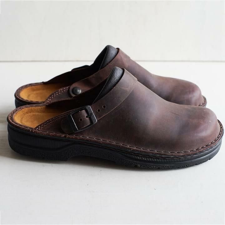 Caramel brown leather orthopedic slippers with a buckle closure on a white background