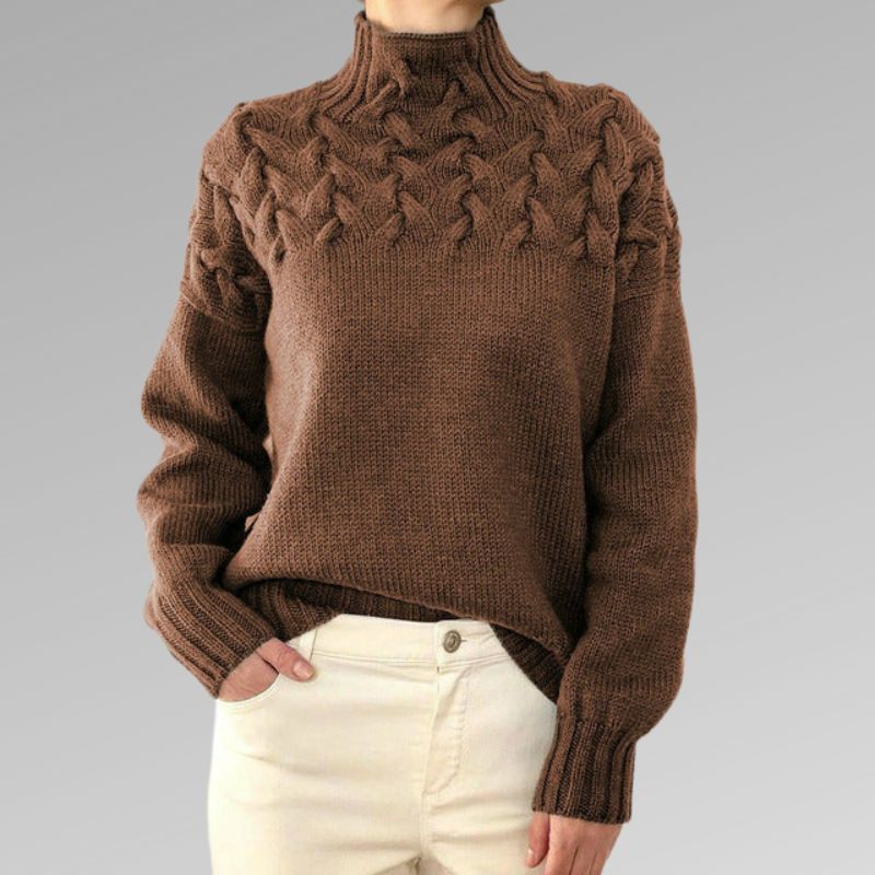 Zimora veelzijdige casual trui in bruin, met een stijlvol gevlochten patroon bij de schouders en een comfortabele hoge kraag. De trui heeft een relaxte pasvorm en lange mouwen, perfect voor een warme en modieuze look. Mooi te combineren met lichte broeken of jeans voor een tijdloze uitstraling.