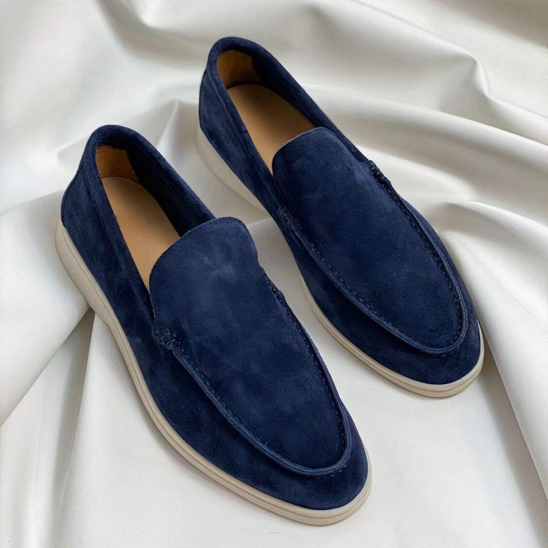 De afbeelding toont een paar Zodara klassieke herenloafers in een diepe blauwe kleur. De loafers zijn gemaakt van hoogwaardig materiaal en hebben een verfijnd, tijdloos ontwerp. Het strakke, minimalistische model is voorzien van een comfortabele zool, waardoor ze zowel stijlvol als praktisch zijn. Deze schoenen bieden een elegante uitstraling voor zowel formele als informele gelegenheden, met een moderne twist die ze perfect maakt voor elke modebewuste man.