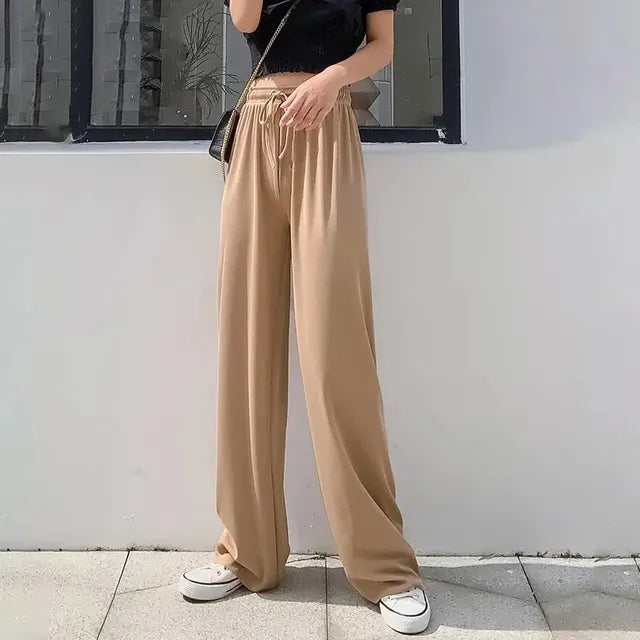 Pantaloni eleganti da donna con fondo a campana drappeggiato in seta ghiaccio e vita alta con gamba dritta