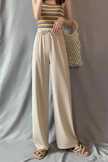 Pantaloni eleganti da donna con fondo a campana drappeggiato in seta ghiaccio e vita alta con gamba dritta