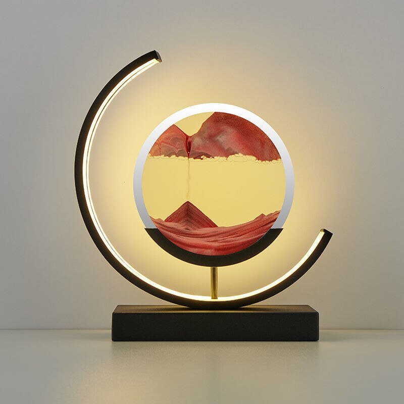 De LumiAura lamp creëert een magisch effect met zijn rode zandlandschap dat zich langzaam verplaatst, en biedt een unieke en rustgevende sfeer in elke kamer. Het ontwerp met een cirkelvormig frame en subtiele verlichting voegt niet alleen functionaliteit toe, maar ook een artistieke flair aan je interieur. Perfect voor het creëren van een kalmerende omgeving die visueel verleidt en verlicht.