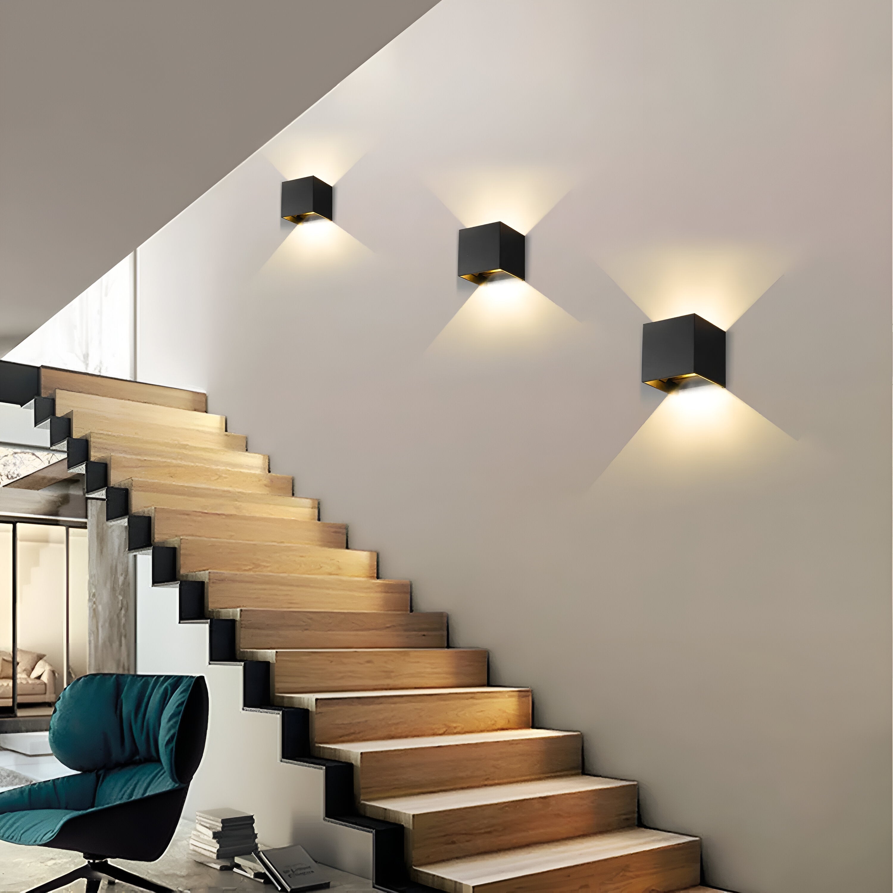 Omnira Glow verstelbare wandlampen geïnstalleerd naast een trap, met een strak, modern ontwerp in zwart met gouden accenten, die zacht, gericht licht verspreiden voor een elegante en functionele verlichting.