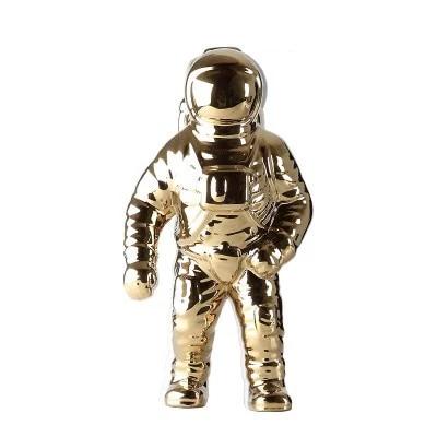 OriaDecor bloemenhouder in de vorm van een astronaut, volledig uitgevoerd in glanzend goudkleurig keramiek. Modern en creatief ontwerp dat een unieke en speelse touch aan elk interieur geeft. Perfect als decoratie of plantenhouder voor een eigentijdse uitstraling.