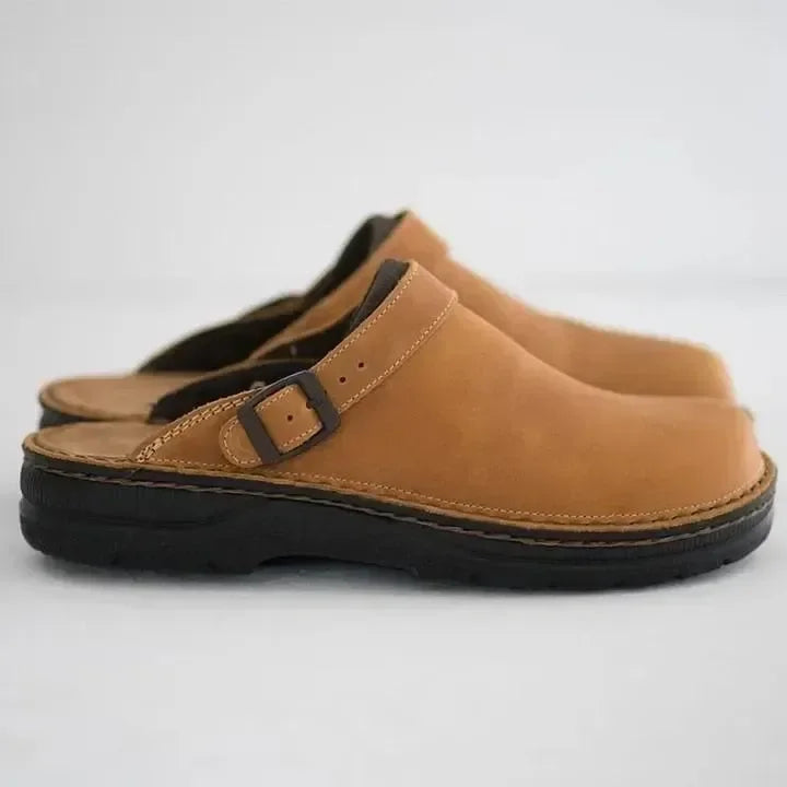 Caramel brown leather orthopedic slippers with a buckle closure on a white background